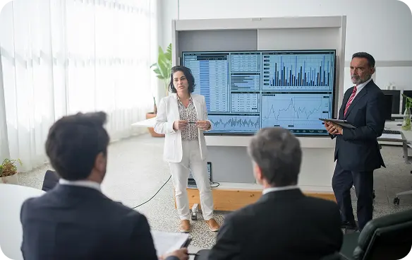Finance professionals analyzing data on a screen